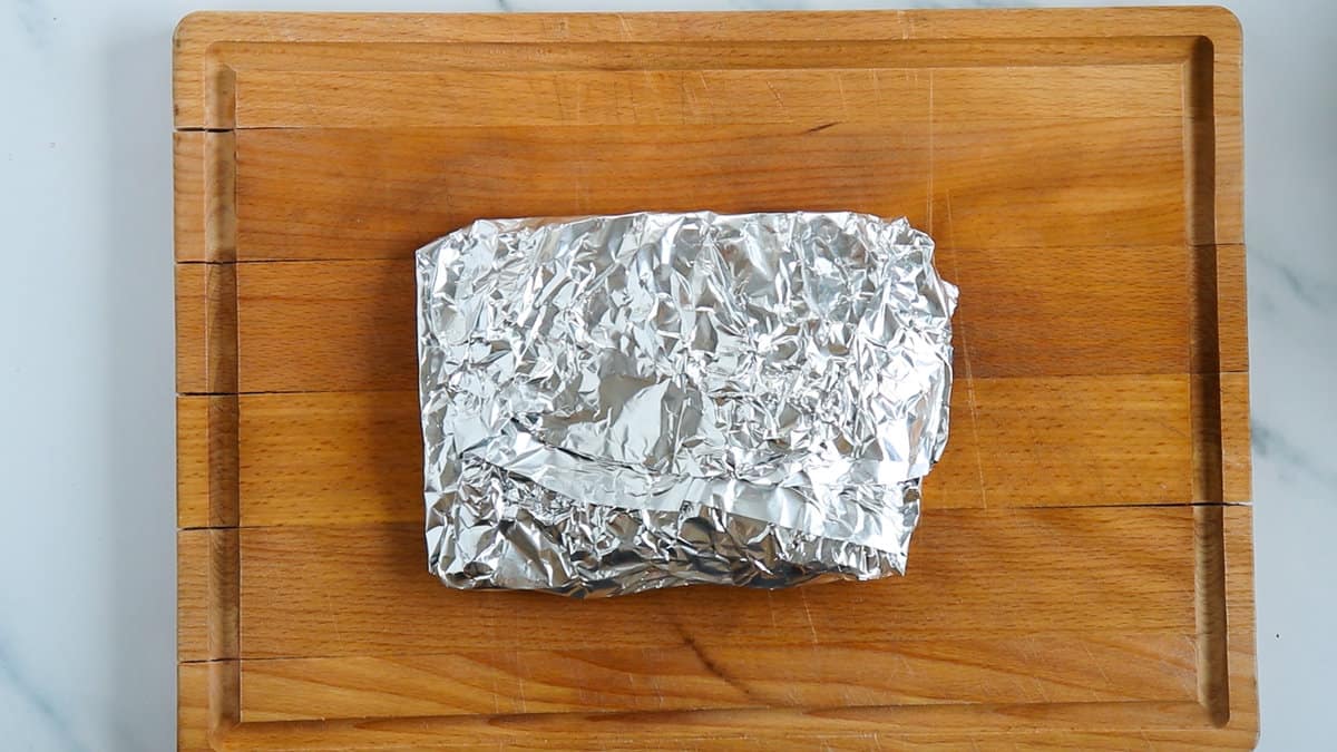 A steak wrapped in aluminium foil.