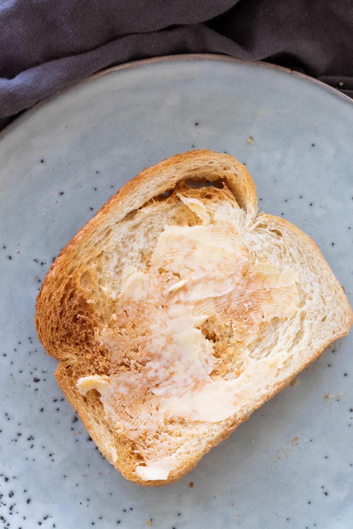 A slice of buttered air fryer toast.