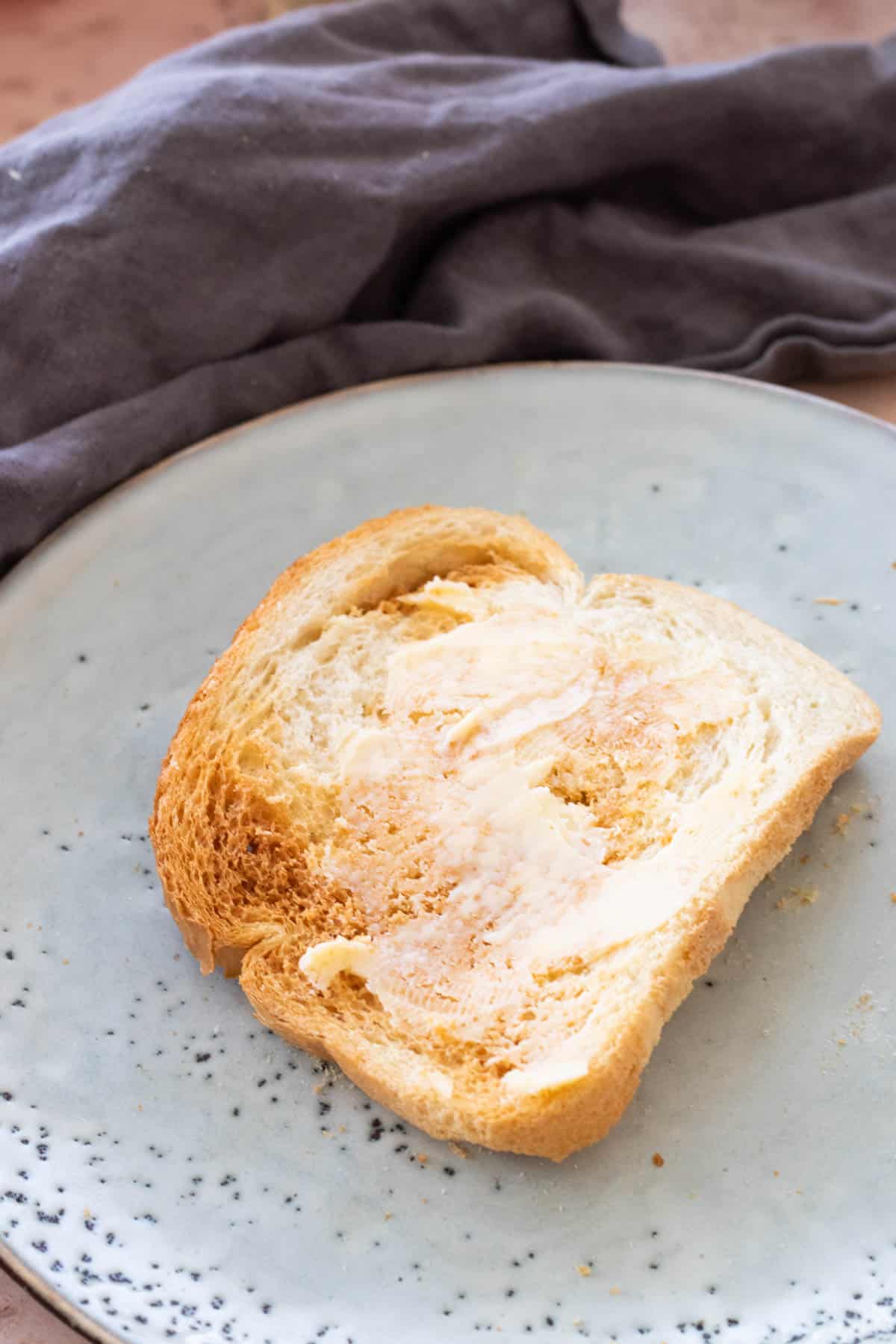 A slice of buttered air fryer toast.