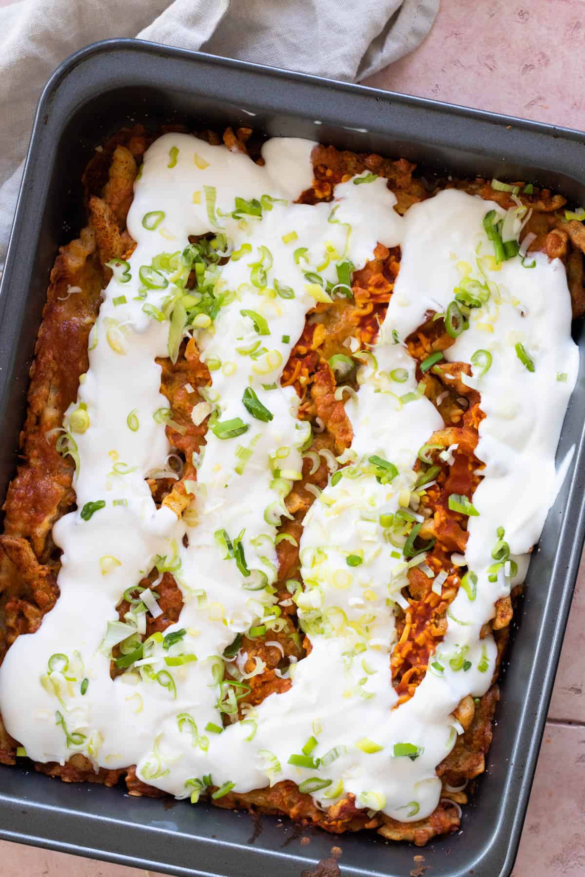 Leftover french fries casserole topped with sour cream.