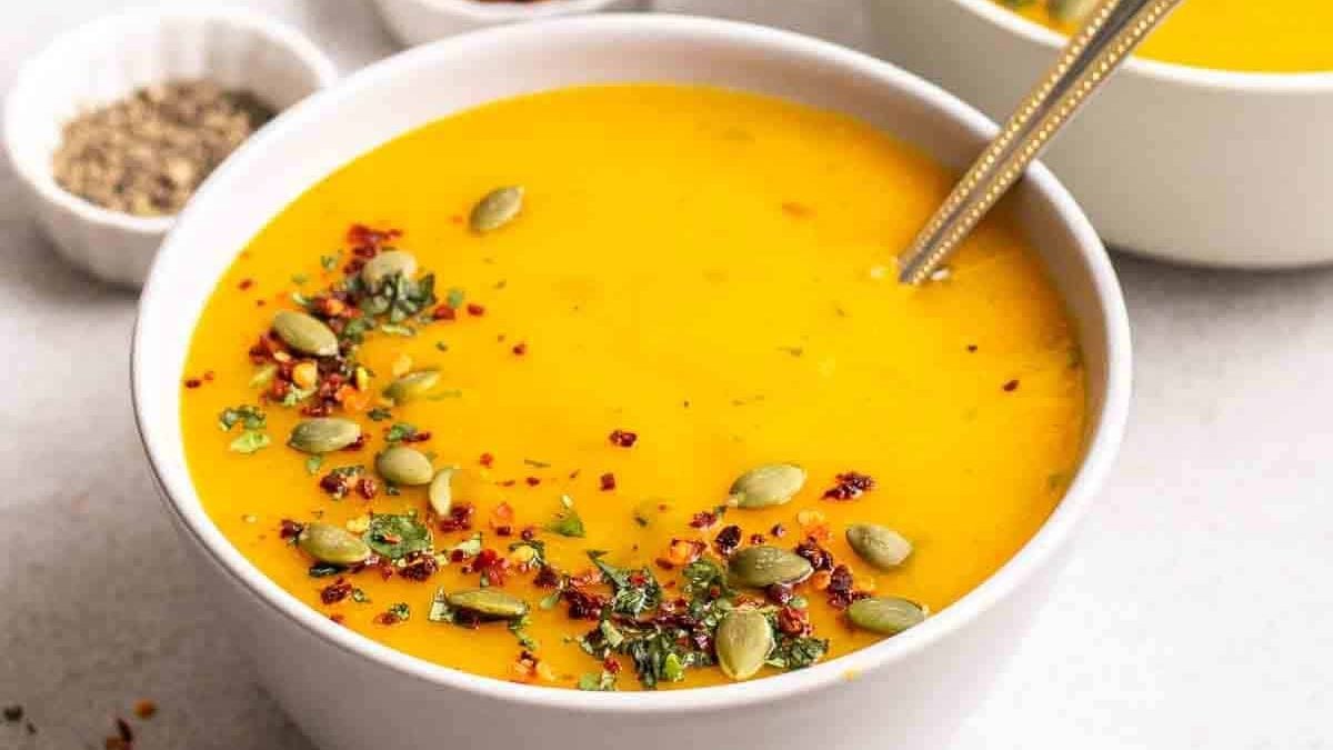 Two bowls of potato pumpkin soup.