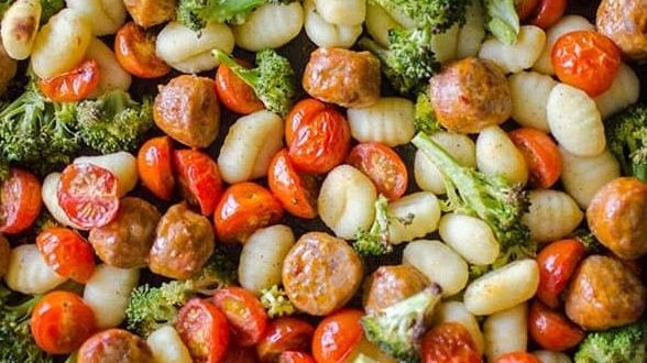 A sheet pan with gnocchi and sausage.
