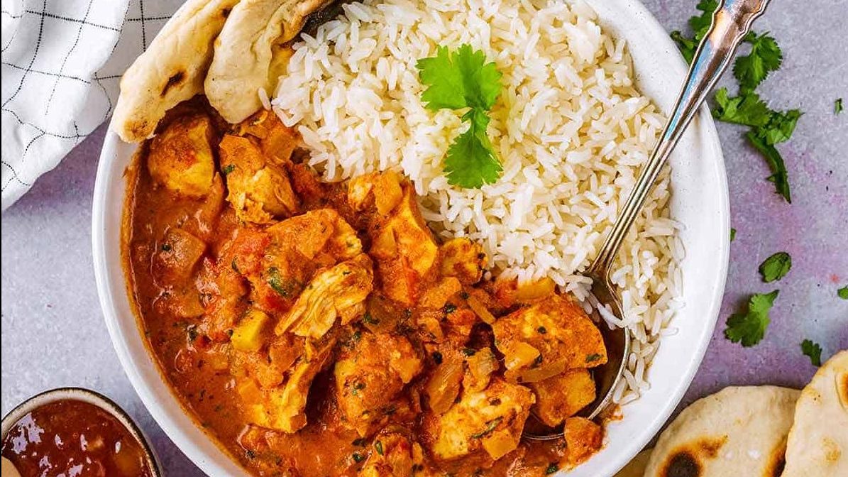 tikka masala in a bowl with rice.