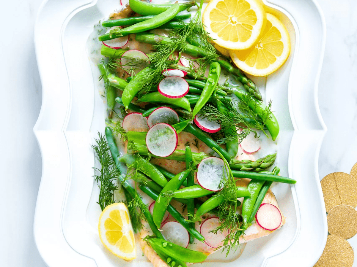 A plate with salmon and spring greens.