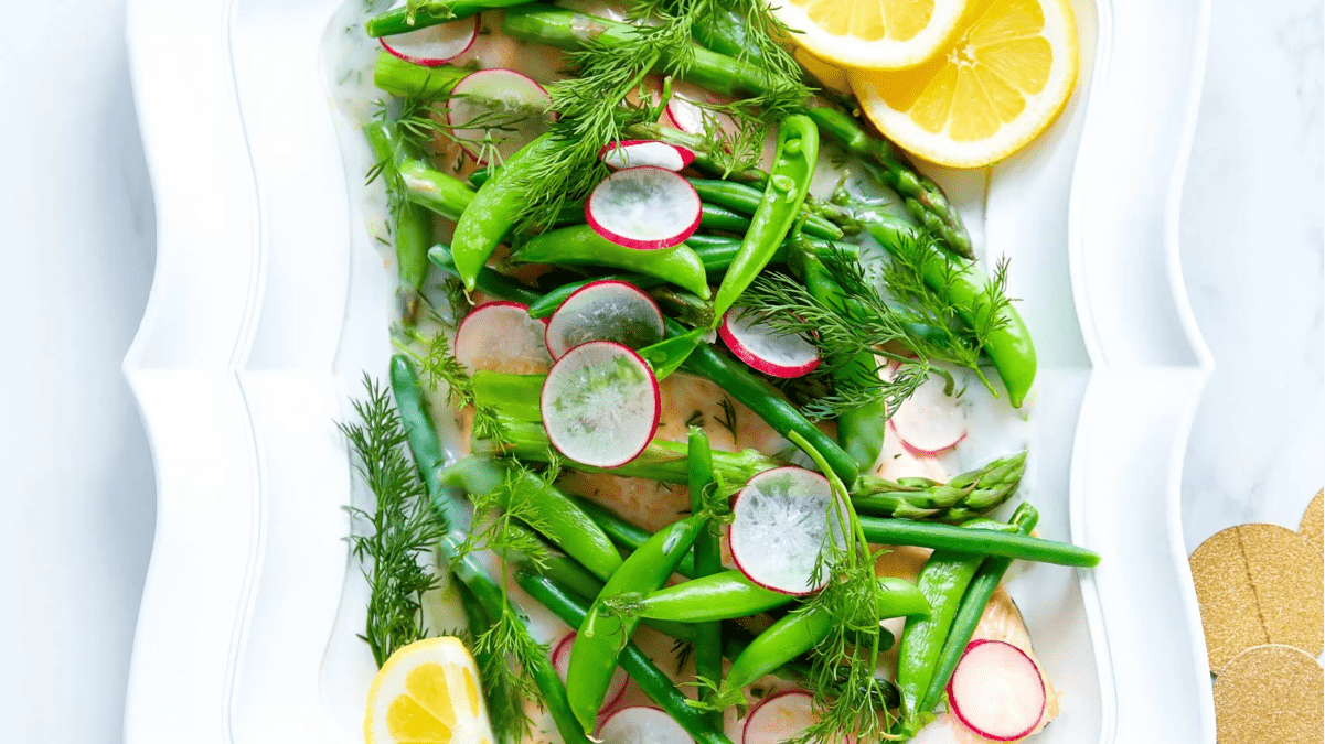 A plate with salmon and spring greens.