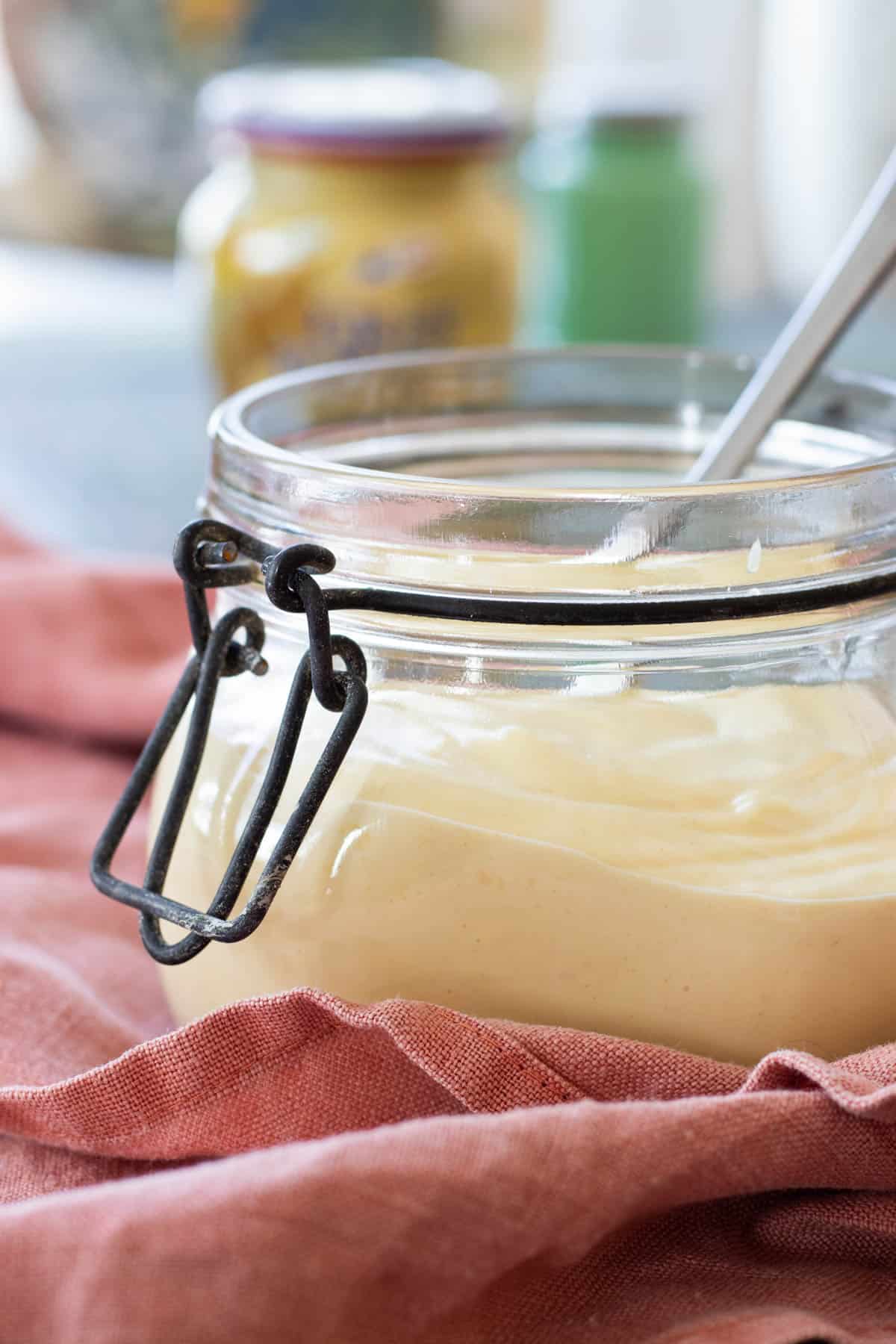 Dijonnaise in a glass jar.