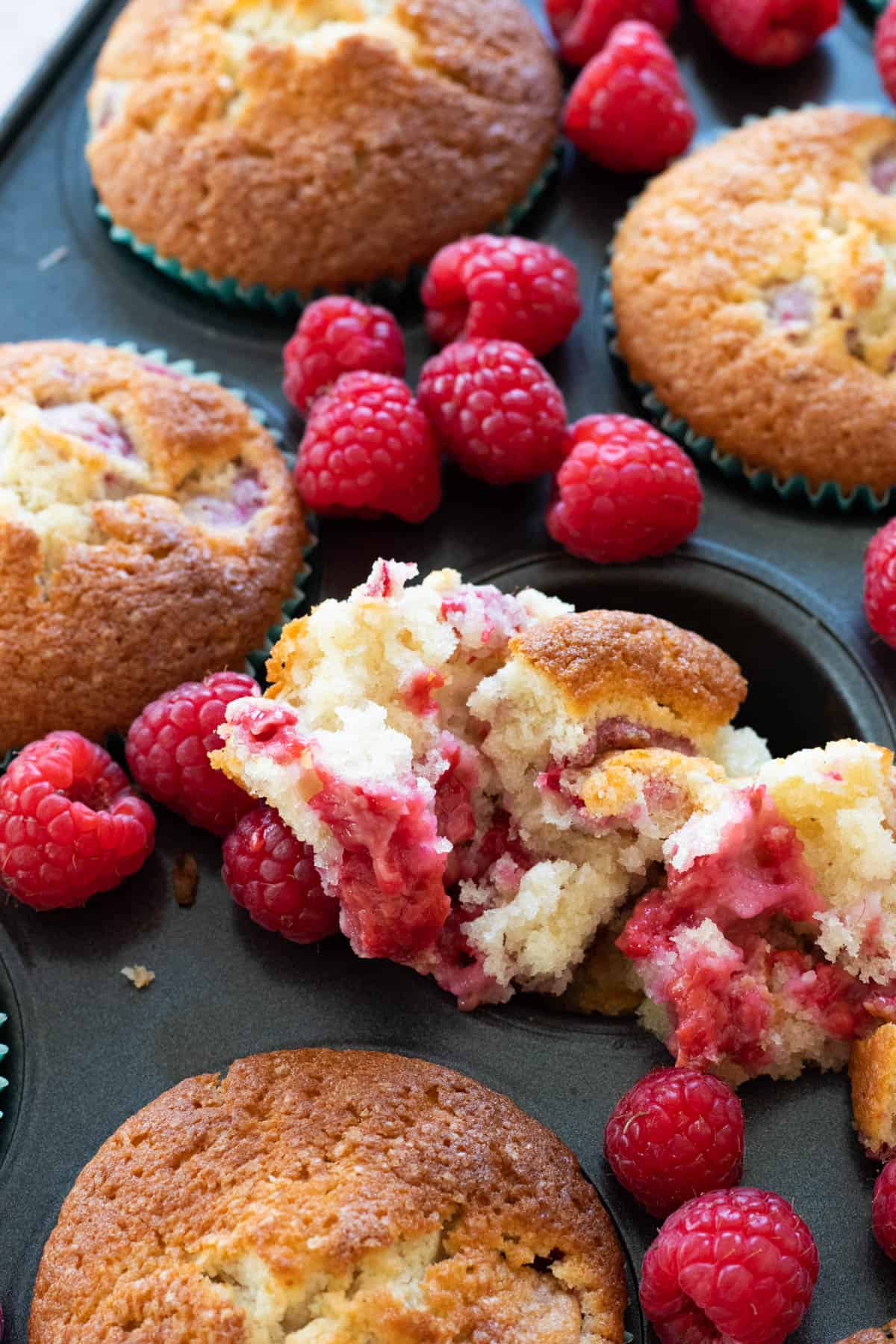 Raspberry muffins in a muffin tin.