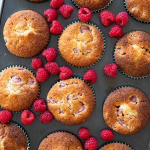 Raspberry muffins in a muffin tin.