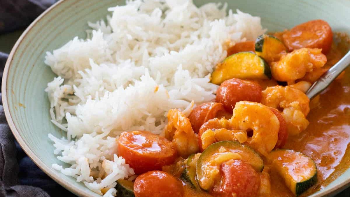 Shrimp curry on a plate with rice.