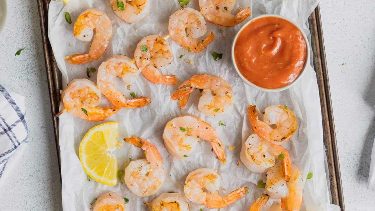 Grilled shrimp with cocktail sauce.