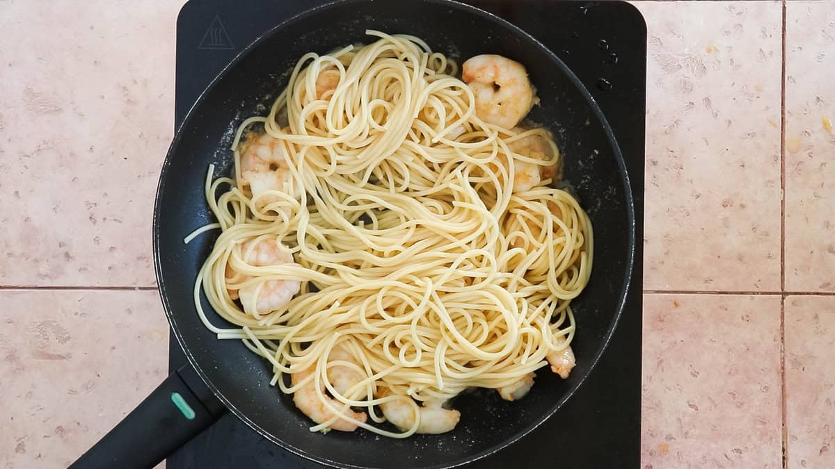 Pasta and shrimp in a pan for making shrimp carbonara.