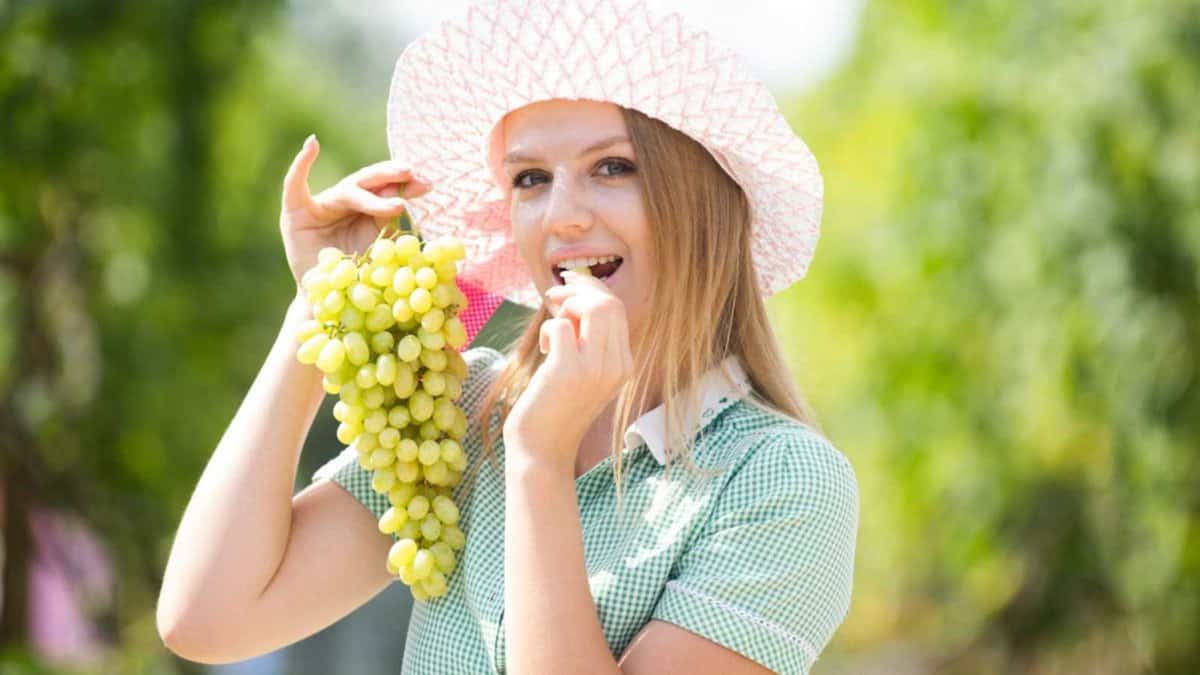Woman eating Grapes