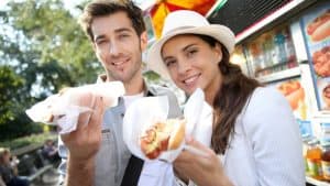 Tourists in New York city eating hot dogs