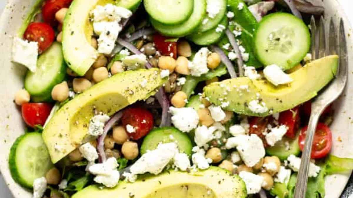 The traditional Greek salad gets a unique twist with the addition of ripe avocado and a lemony citrus vinaigrette