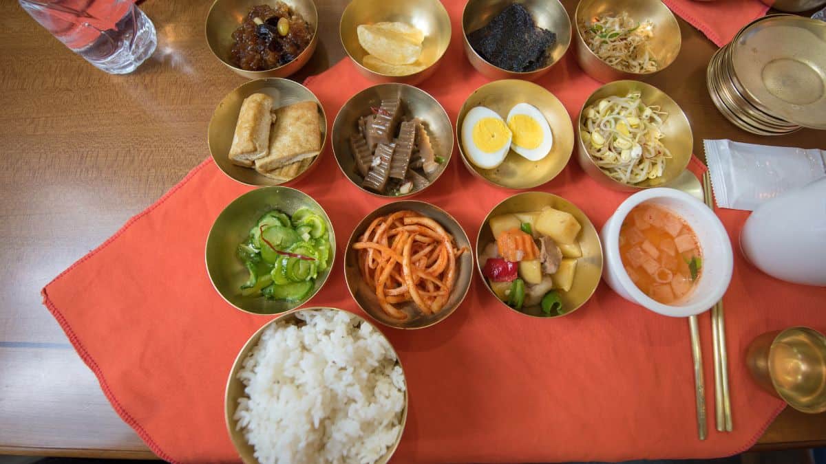 A table filled with traditional North Korean food dishes.