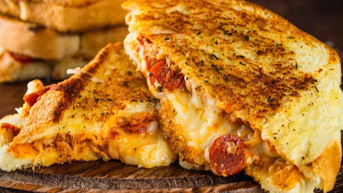 A pizza grilled cheese with melting cheese.