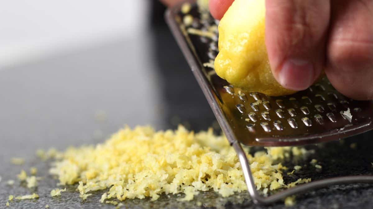 A lemon being grated on a microplane.