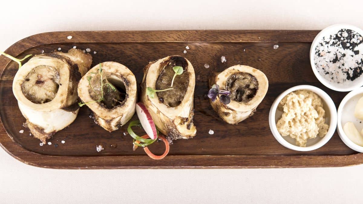 Bone marrow served on a wooden board.