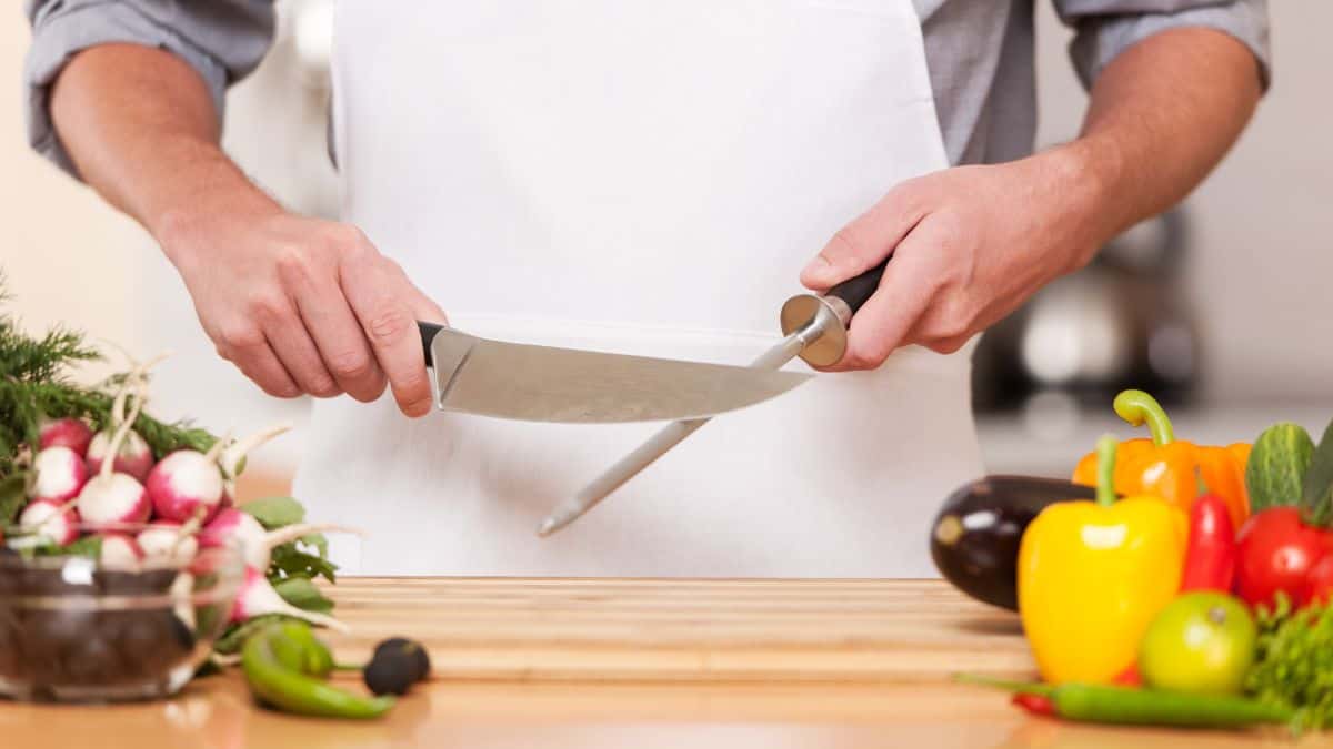 A person sharpening a knife.