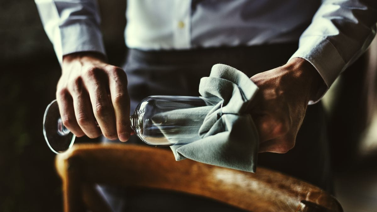 A man cleaning a wine glass.