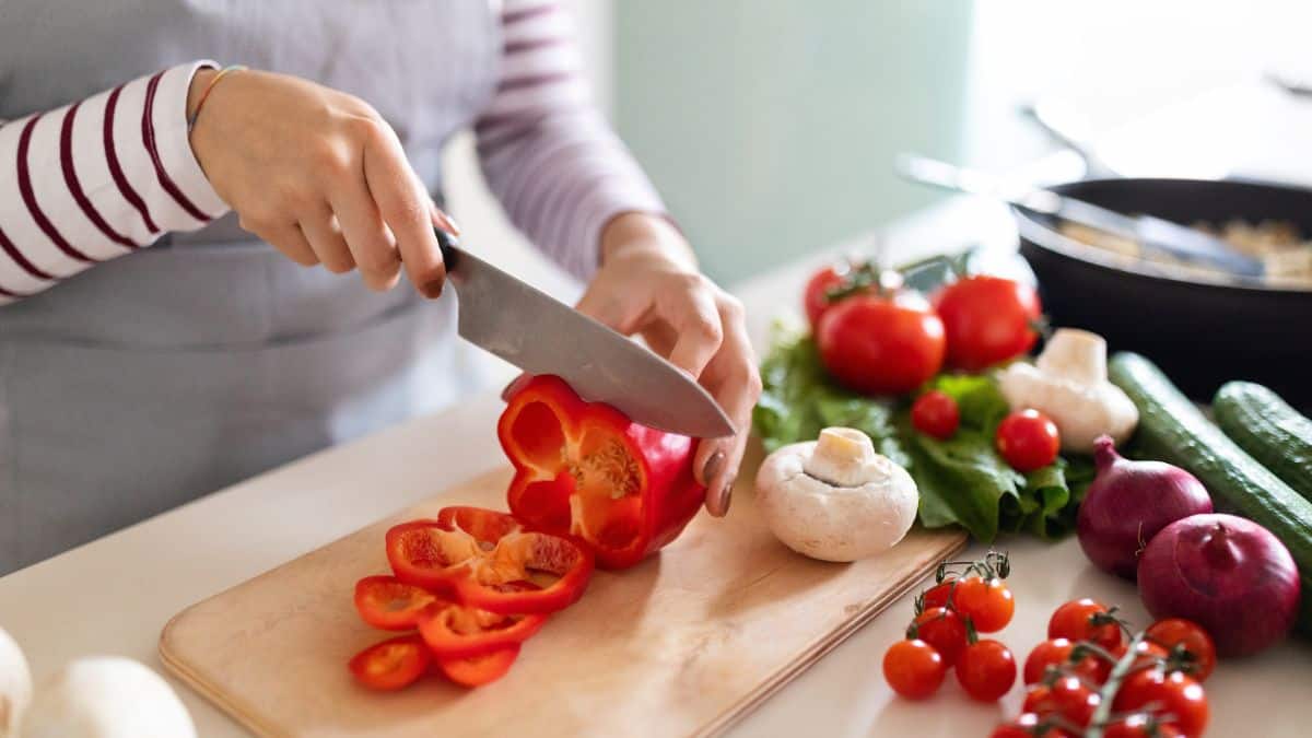 A person slicing bell peppers.