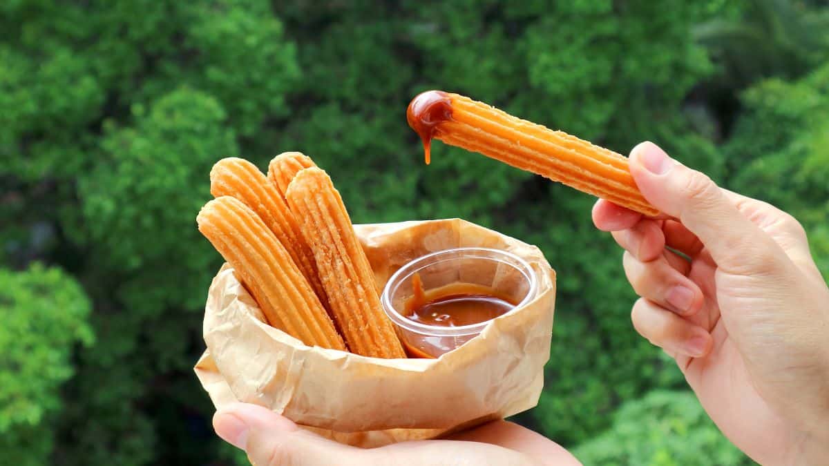 A churro that has been dipped in chocolate sauce.