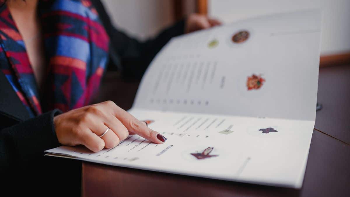 A woman pointing to an item on a menu.