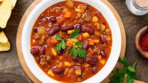 A bowl of chili with beans and corn.