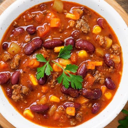 A bowl of chili with beans and corn.