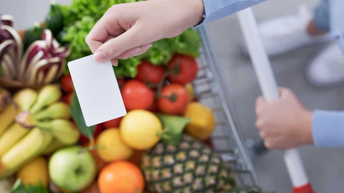 A woman paying with a white card.