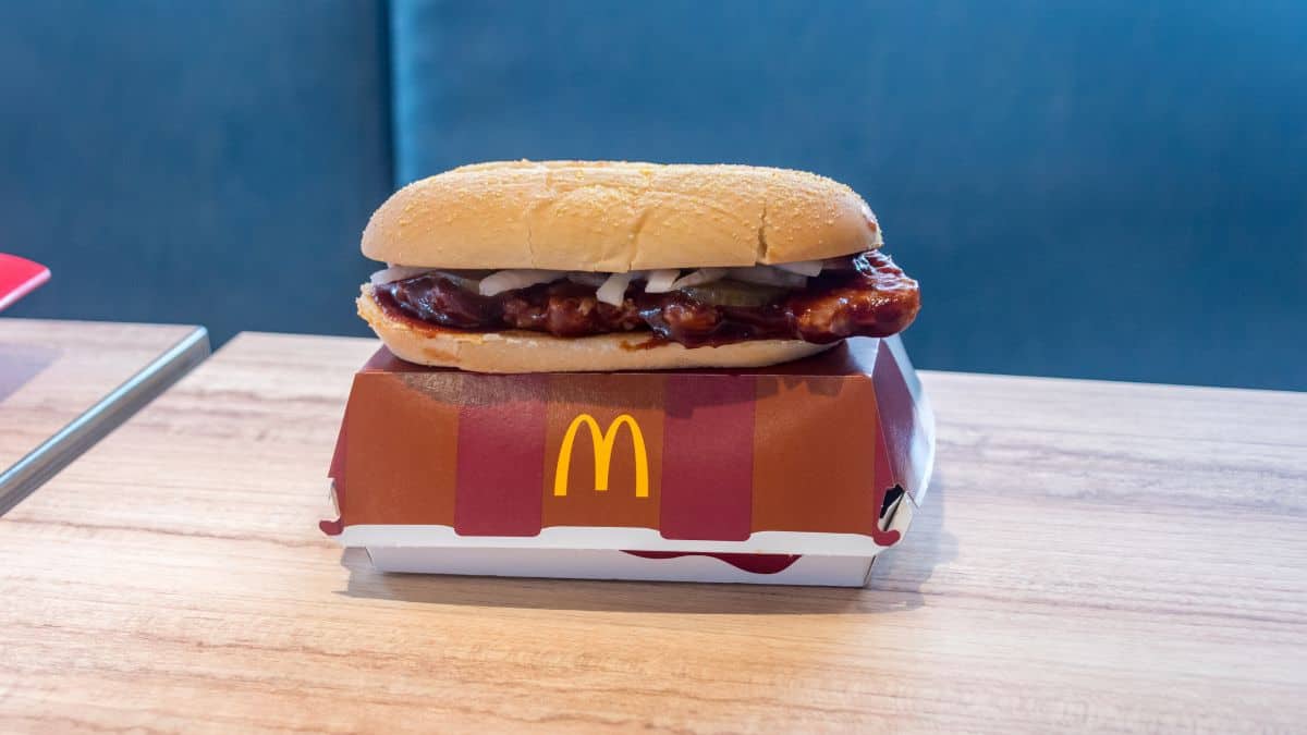 A McRib burger on top of its packaging.