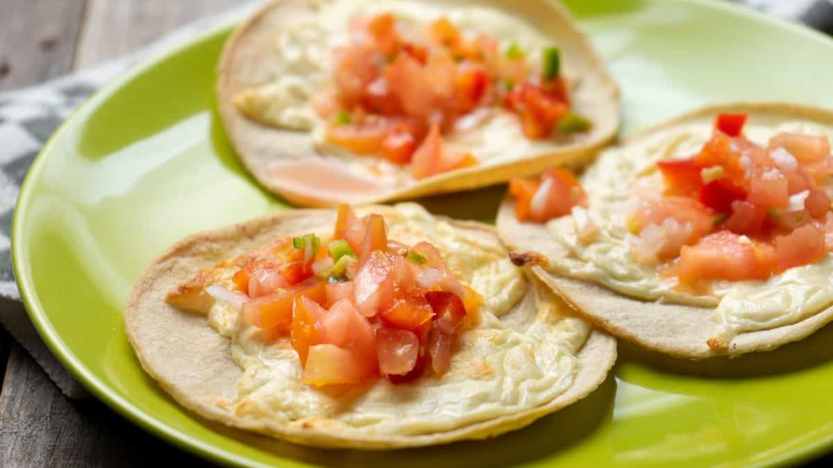 Open faced quesadillas topped with tomatoes.