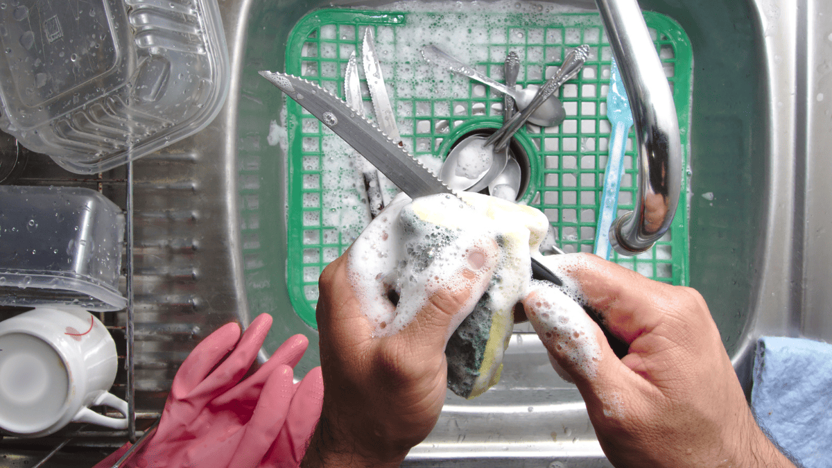 Washing a knife by hand.