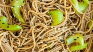 A bowl full of soba noodle salad.