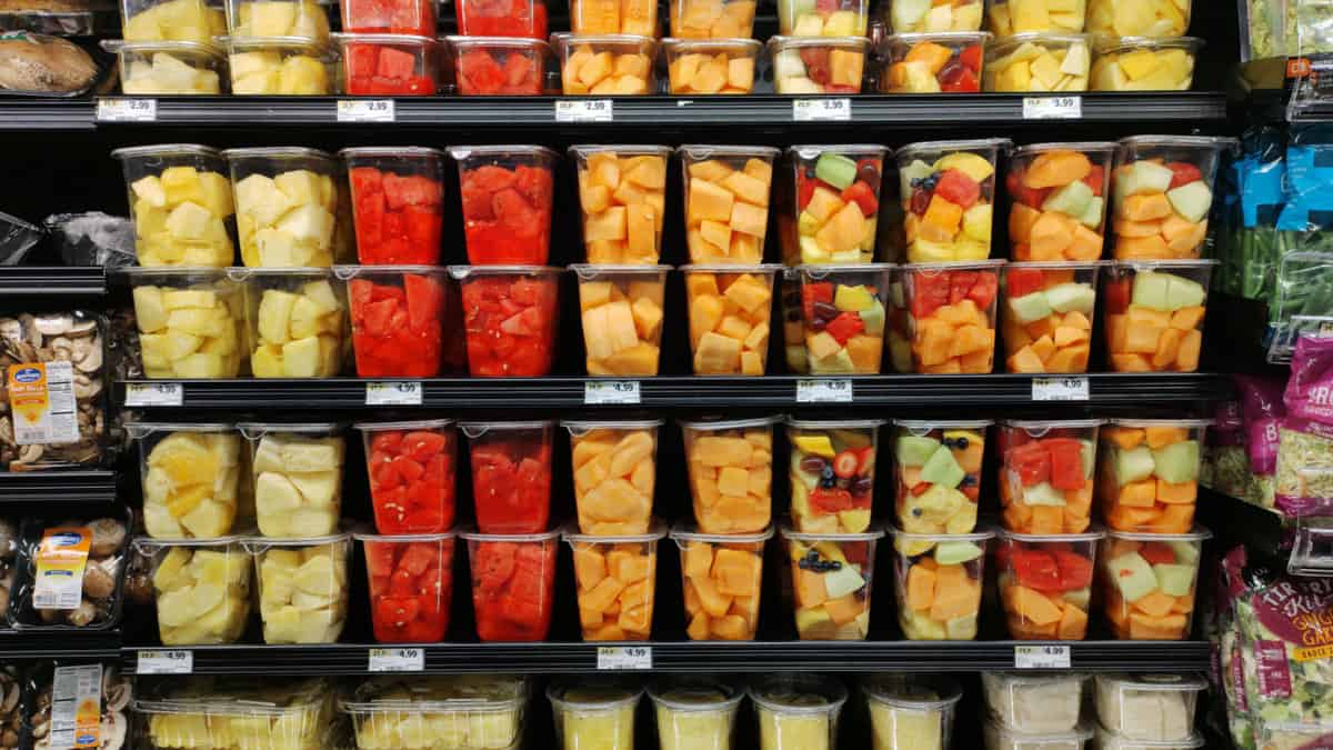 Precut fruit on a shelf in a store.