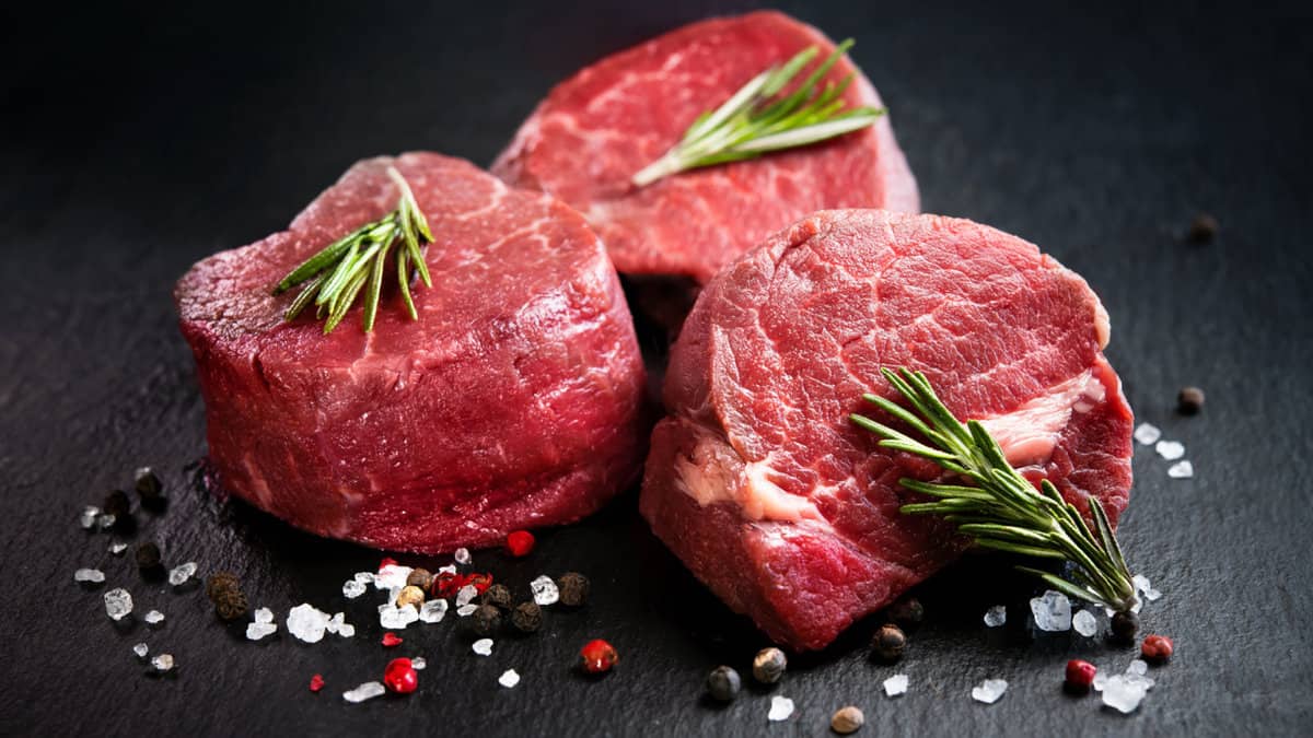 Three raw filet mignon steaks.