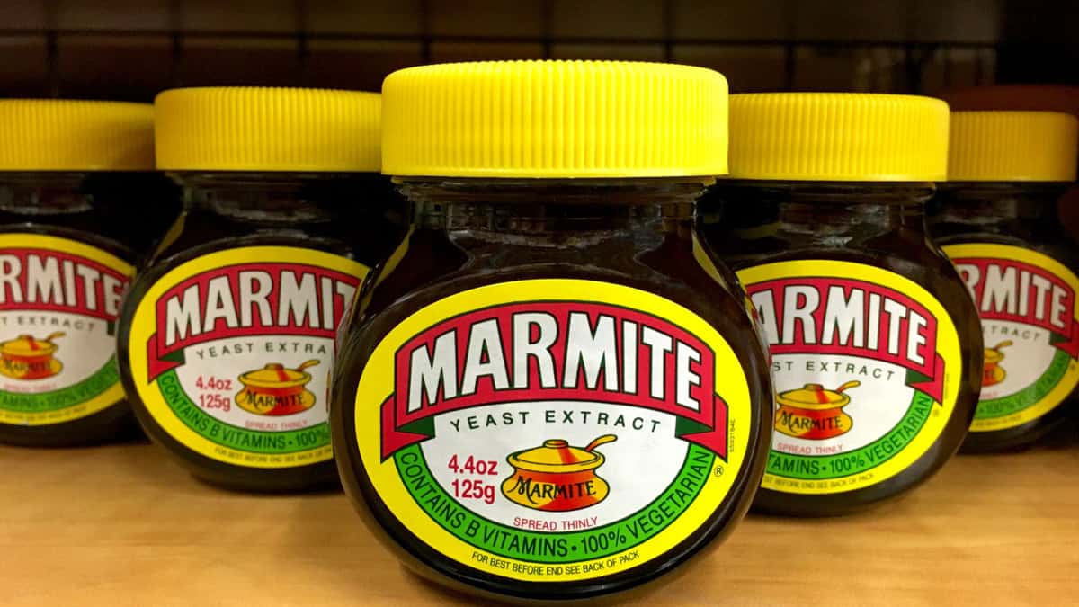 Jars of marmite on a store shelf.