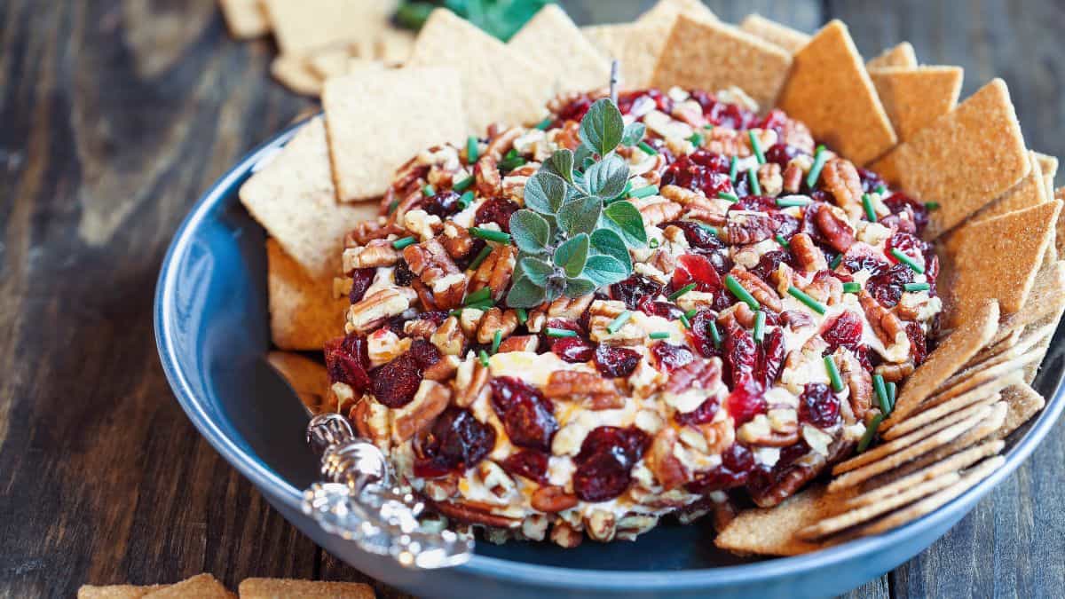 A cheese ball with cranberries and nuts.