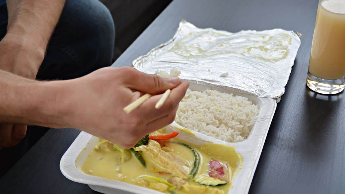 Eating rice and curry with chopsticks.