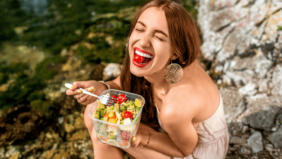 A woman eating a salad.