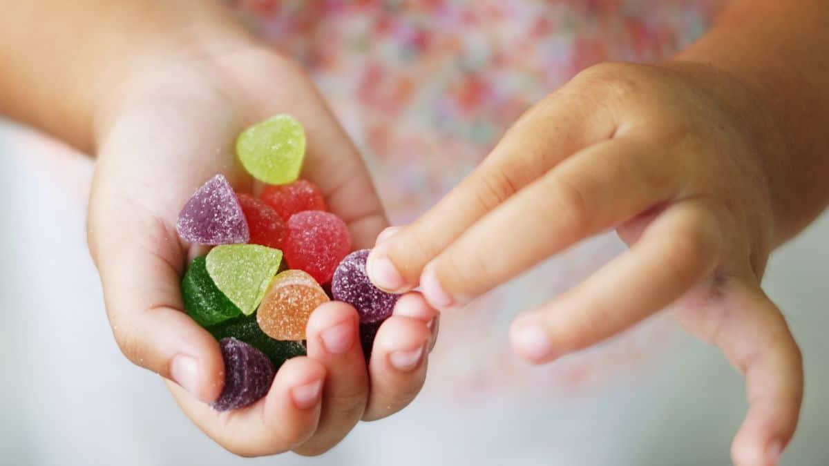 A child holding candy in their hand.