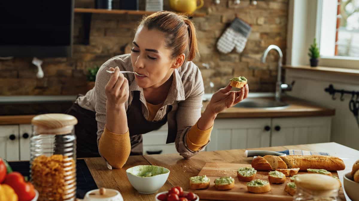 A woman tasting her food.