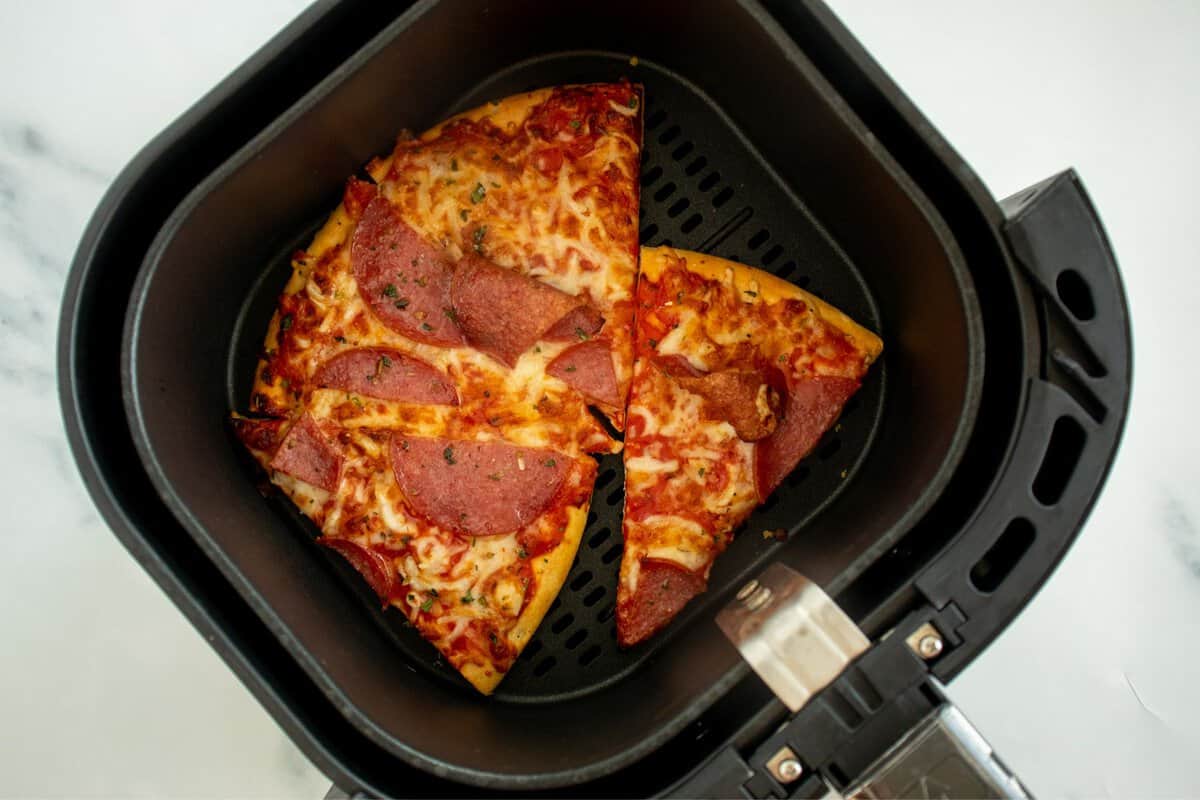 Pizza slices in an air fryer.
