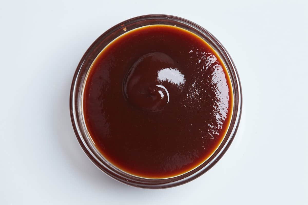 A small bowl of steak sauce or barbecue sauce.