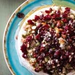 Baked brie topped with nuts and cranberries,