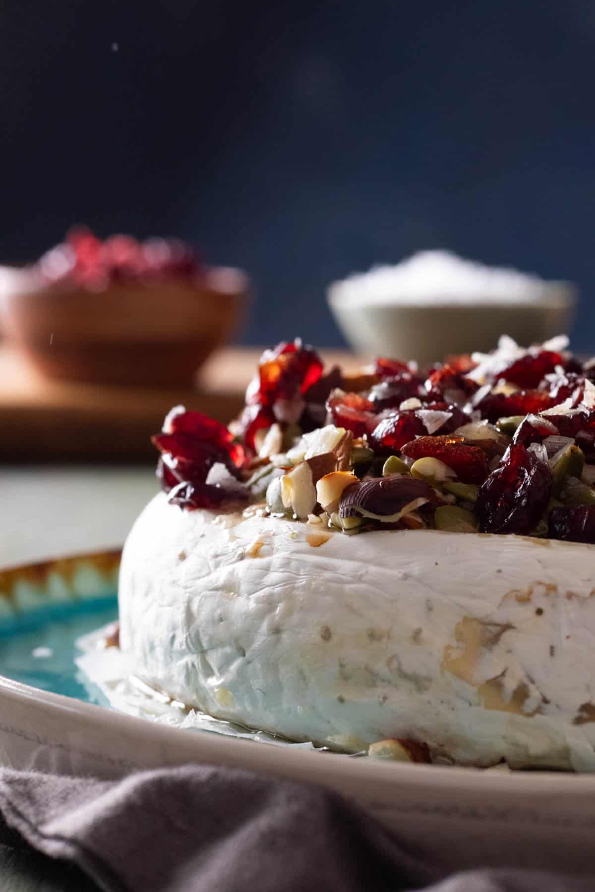 Baked brie topped with nuts and cranberries,
