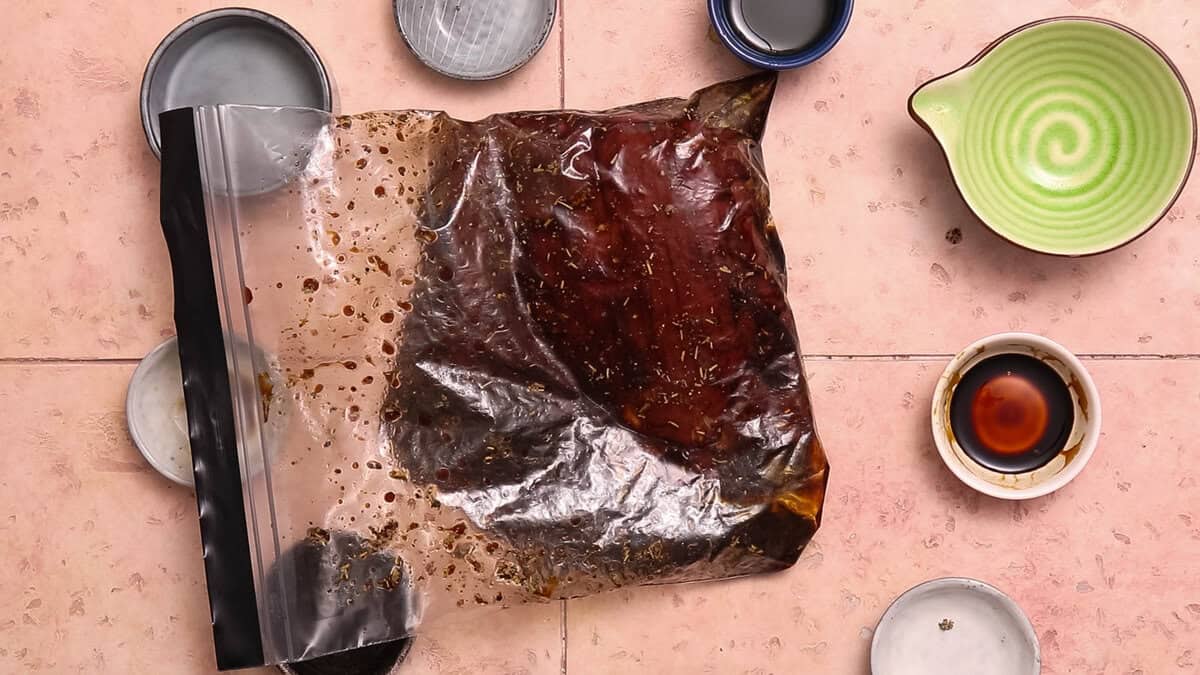 Flank steak and marinade in a plastic bag.