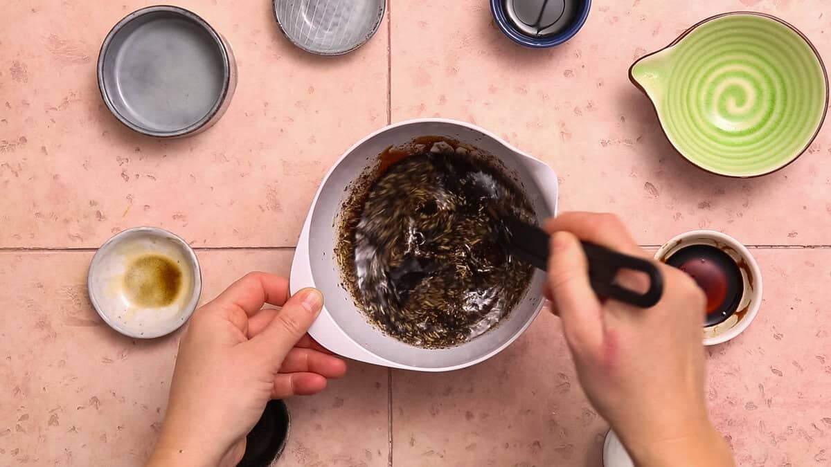 Making marinade for air fryer skirt steak or flank steak by mixing together lemon juice, soy sauce, honey, herbs and spices.