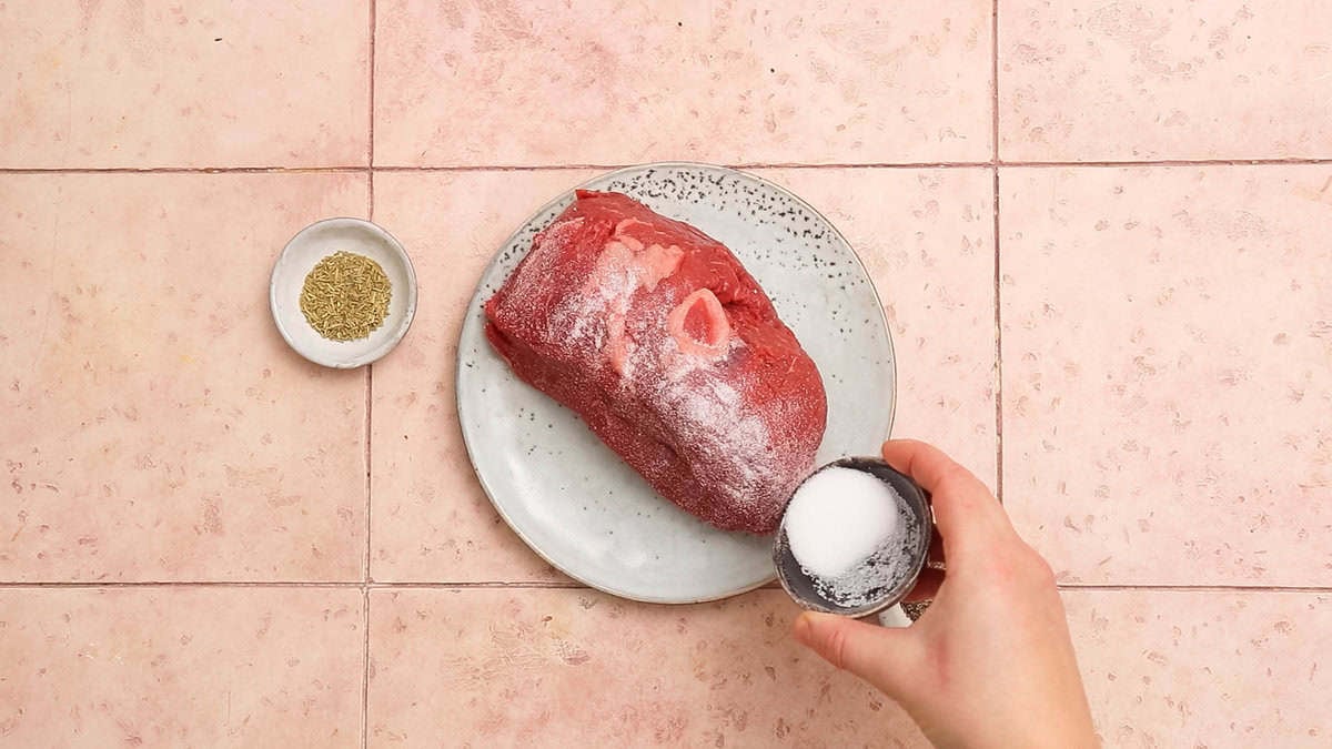 Seasoning roast beef.