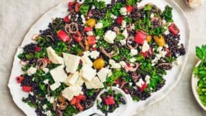 A plate full of black lentil and feta cheese salad.